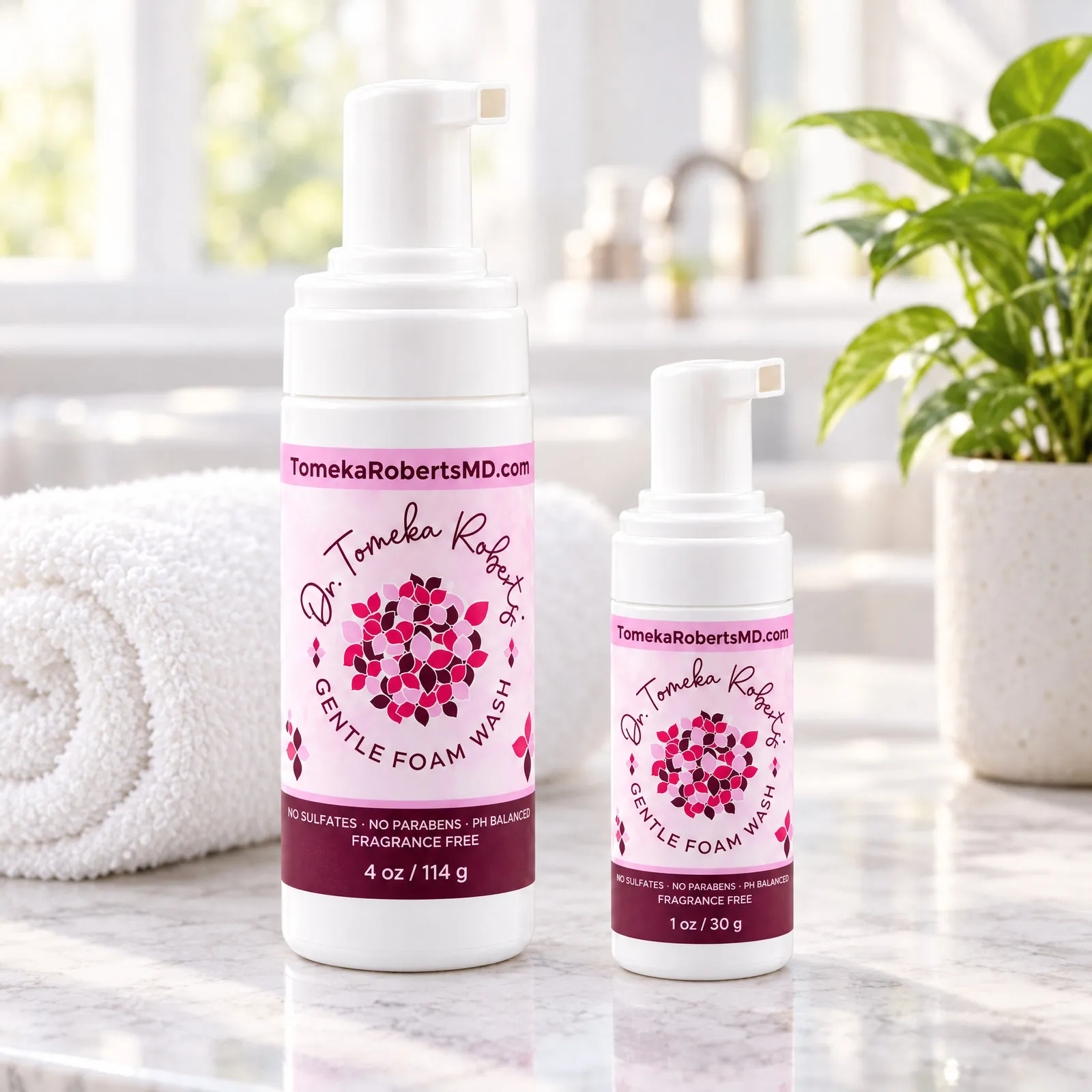Both Fragrance-Free sizes on a marble bathroom counter with a towel and a potted plant