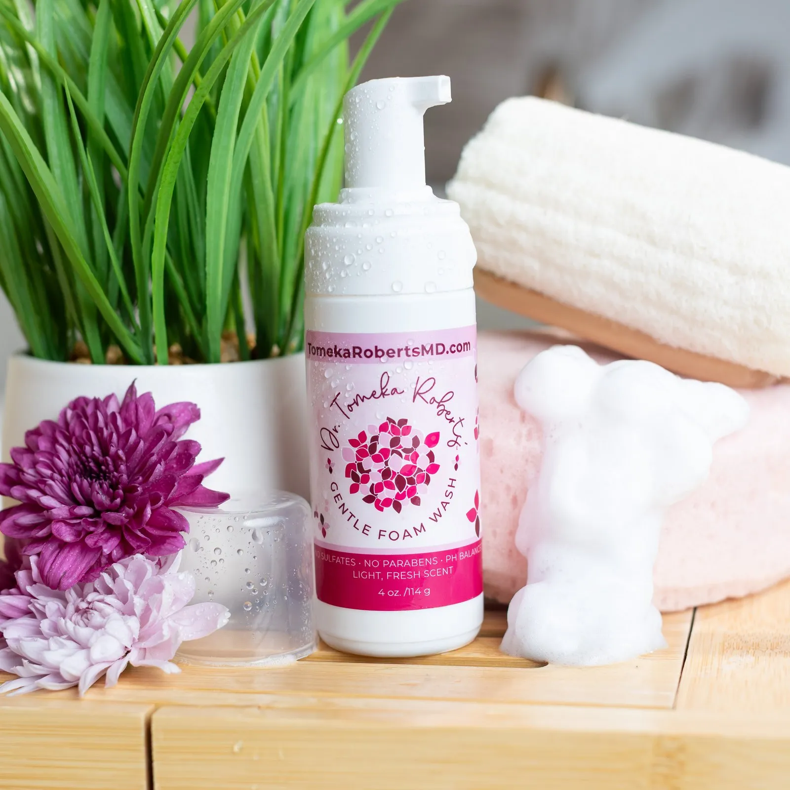 Fresh Scent Gentle Foam Wash styled with foam, greenery and a rolled towel